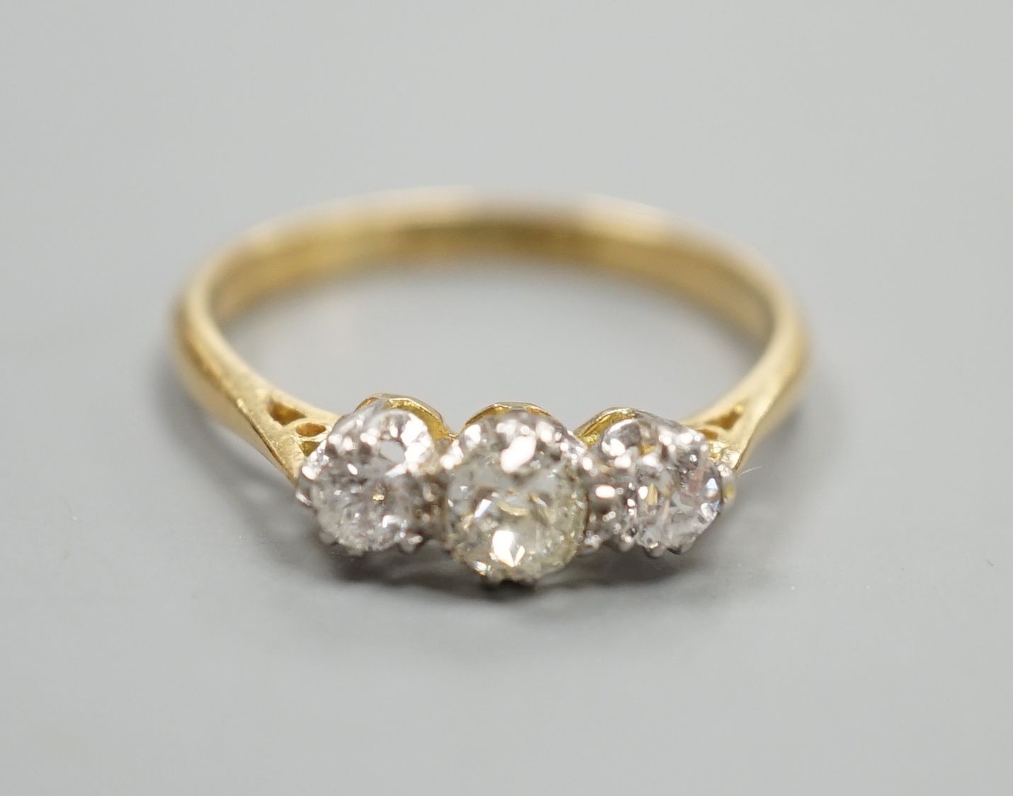 An 18ct & plat, three stone diamond ring, size L, gross weight 2.3 grams.